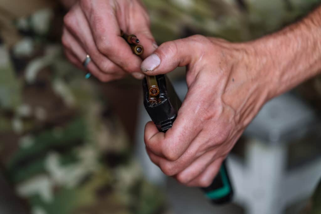 Man loading M4 magazine for personal defense against drones
